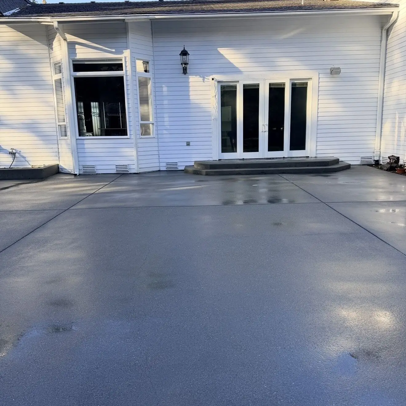 Front entry and concrete after pressure washing, visibly brighter and more uniform