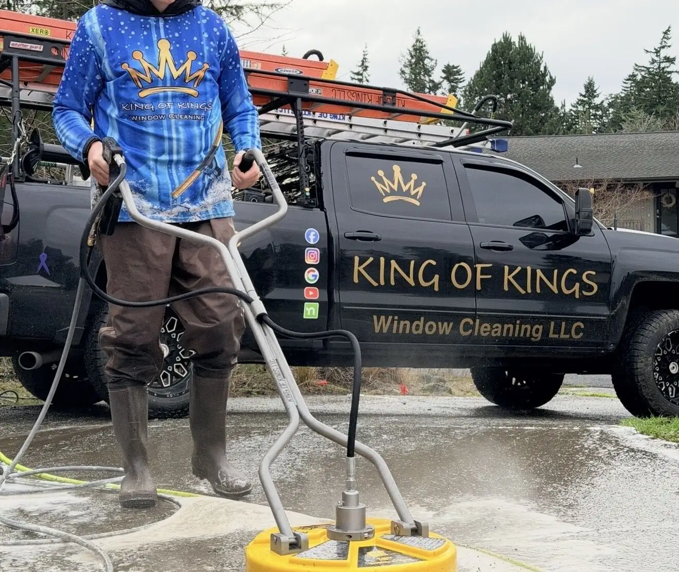 Technician running a professional surface cleaner across concrete beside the company truck